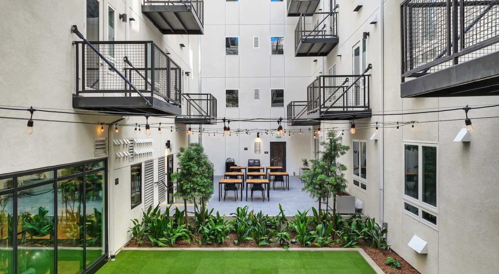 Cutting-edge amenities at your fingertips an aerial image of many balconies above an activity field