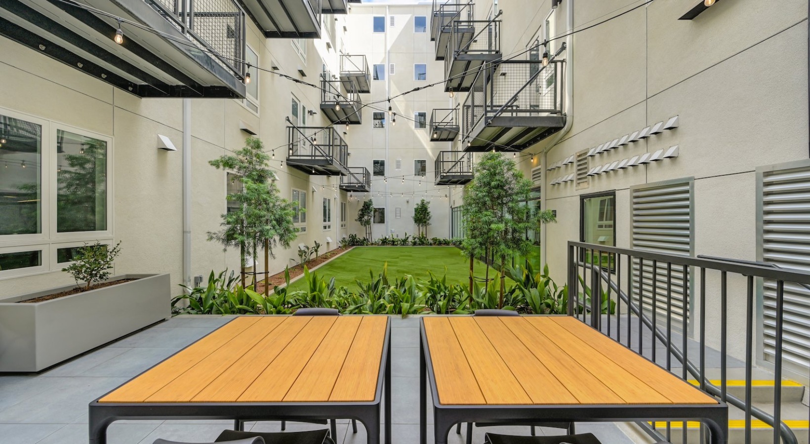 State-of-the-art amenities a spacious patio with tables and greenery