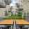 a spacious patio with tables and greenery