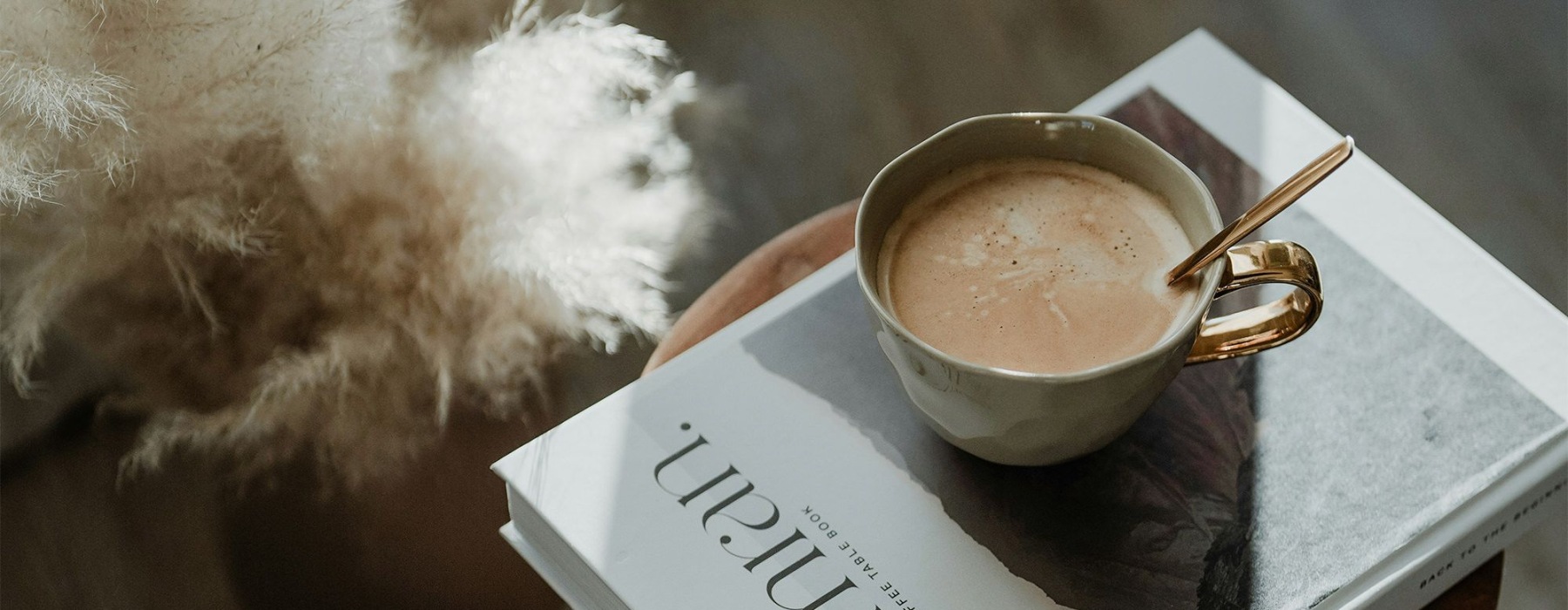 a book and coffee on a wooden stool