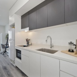 kitchen with ample counter-space, modern appliances and bright lighting